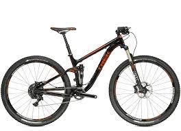 Trek Fuel EX 9.8: Mountain bike with a black and orange design, featuring a lightweight frame, wide tires, and front suspension, designed for off-road cycling.