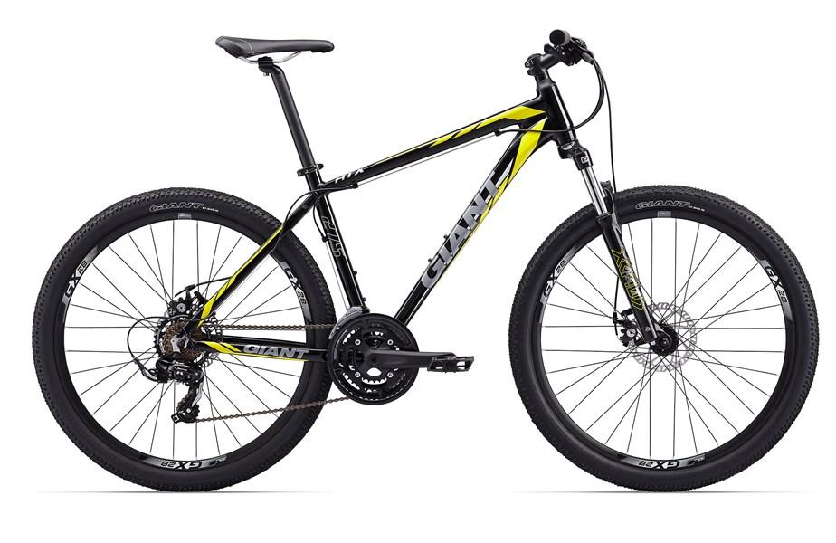 Giant ATX 27.5 2: A black and yellow Giant mountain bike positioned on a white background, showcasing its features including thick tires, a sturdy frame, and a suspension fork.
