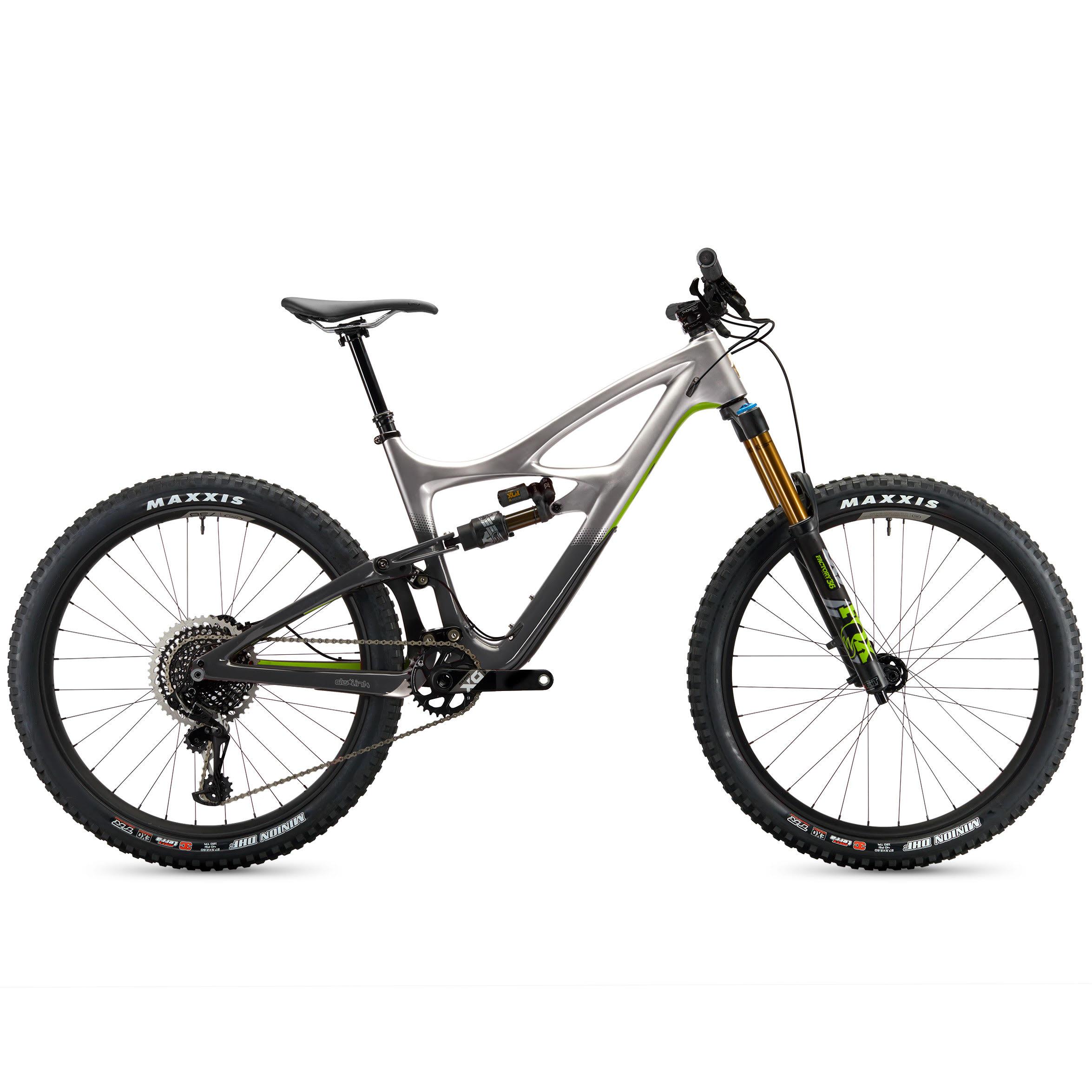 Ibis Mojo HD4: A modern mountain bike featuring a sleek grey and black carbon frame, large knobby tires labeled "Maxxis," and an advanced suspension system. The bike showcases a streamlined design with a prominent shock absorber, a dropper seat post, and a combination of gears suitable for off-road terrain. The overall look emphasizes performance and durability.