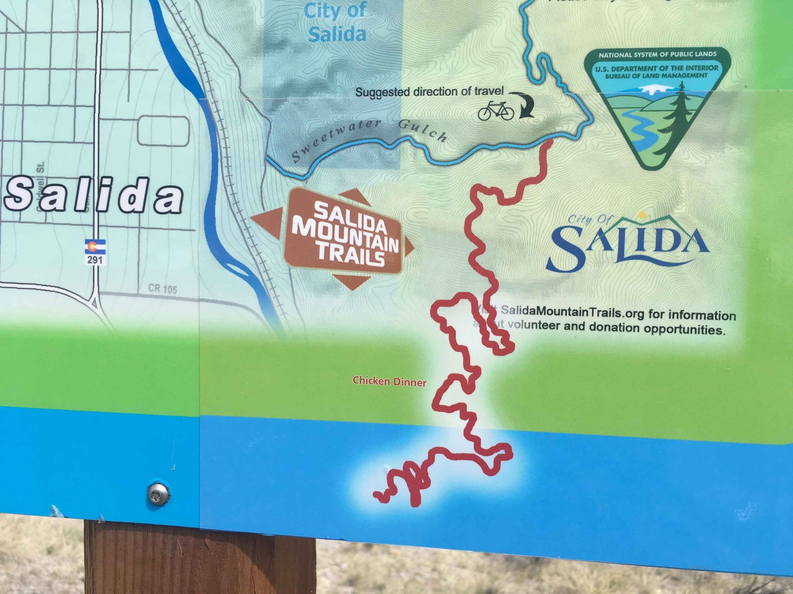 Map of Salida, Colorado, highlighting the Salida Mountain Trails. Features a marked trail in red labeled "Chicken Dinner" and provides information on suggested travel directions and volunteer opportunities through SalidaMountainTrails.org. Arkansas Hills mountain bike trail.