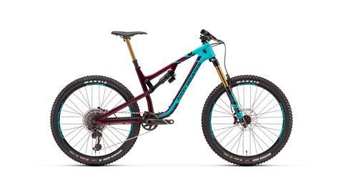 Rocky Mountain Altitude: A modern mountain bike featuring a sleek design with a maroon and turquoise color scheme. The bike has wide tires, front suspension forks, and a prominent frame, ideal for off-road trails.