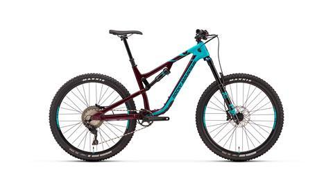 Rocky Mountain Altitude: A mountain bike featuring a burgundy frame with teal accents, designed for off-road cycling. It has wide, knobby tires and a sturdy build suitable for various terrains.