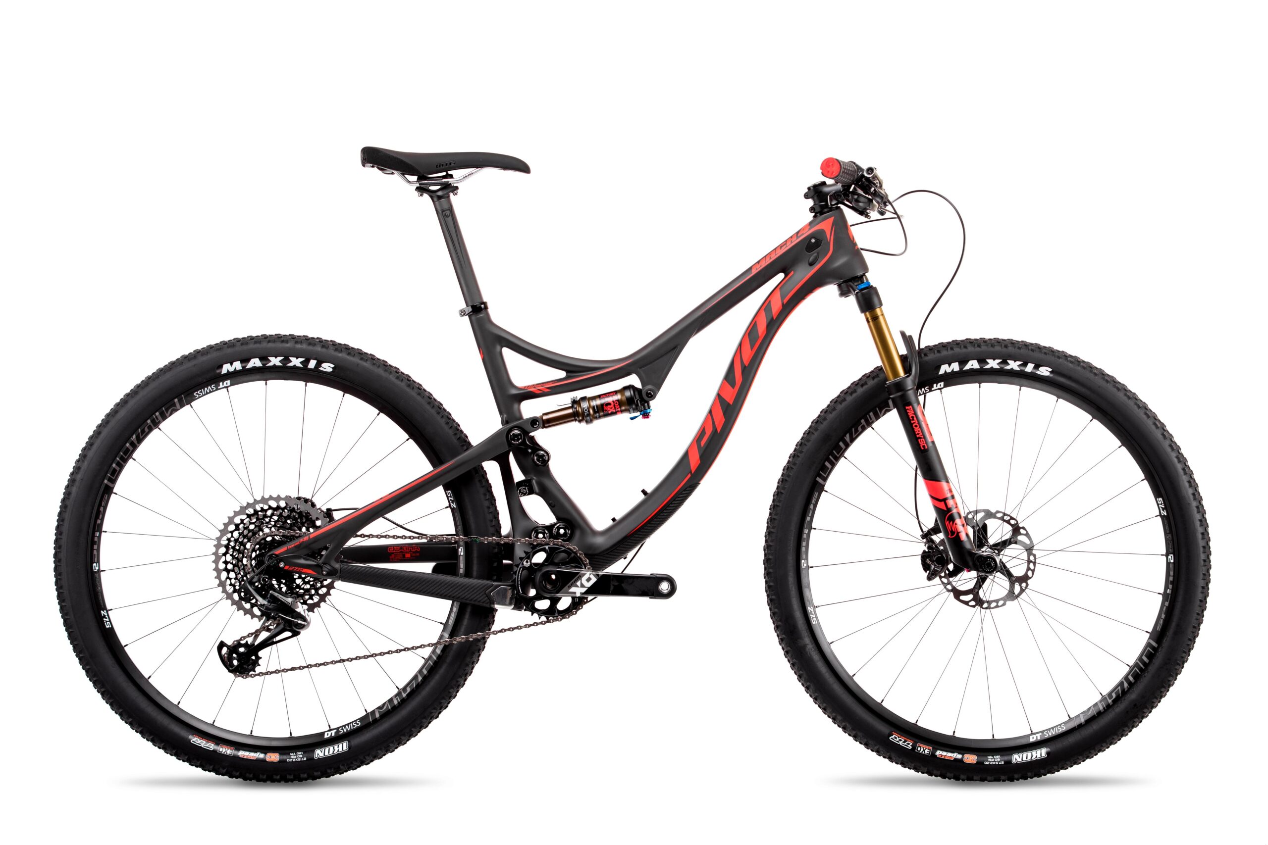 Pivot Mach 4: A sleek mountain bike featuring a black and red frame, designed for durability and performance. The bike has wide tires, a modern suspension system, and a gear system with a visible cassette and derailleur. The handlebars include controls for adjusting settings, and it showcases a prominent brand logo on the frame.