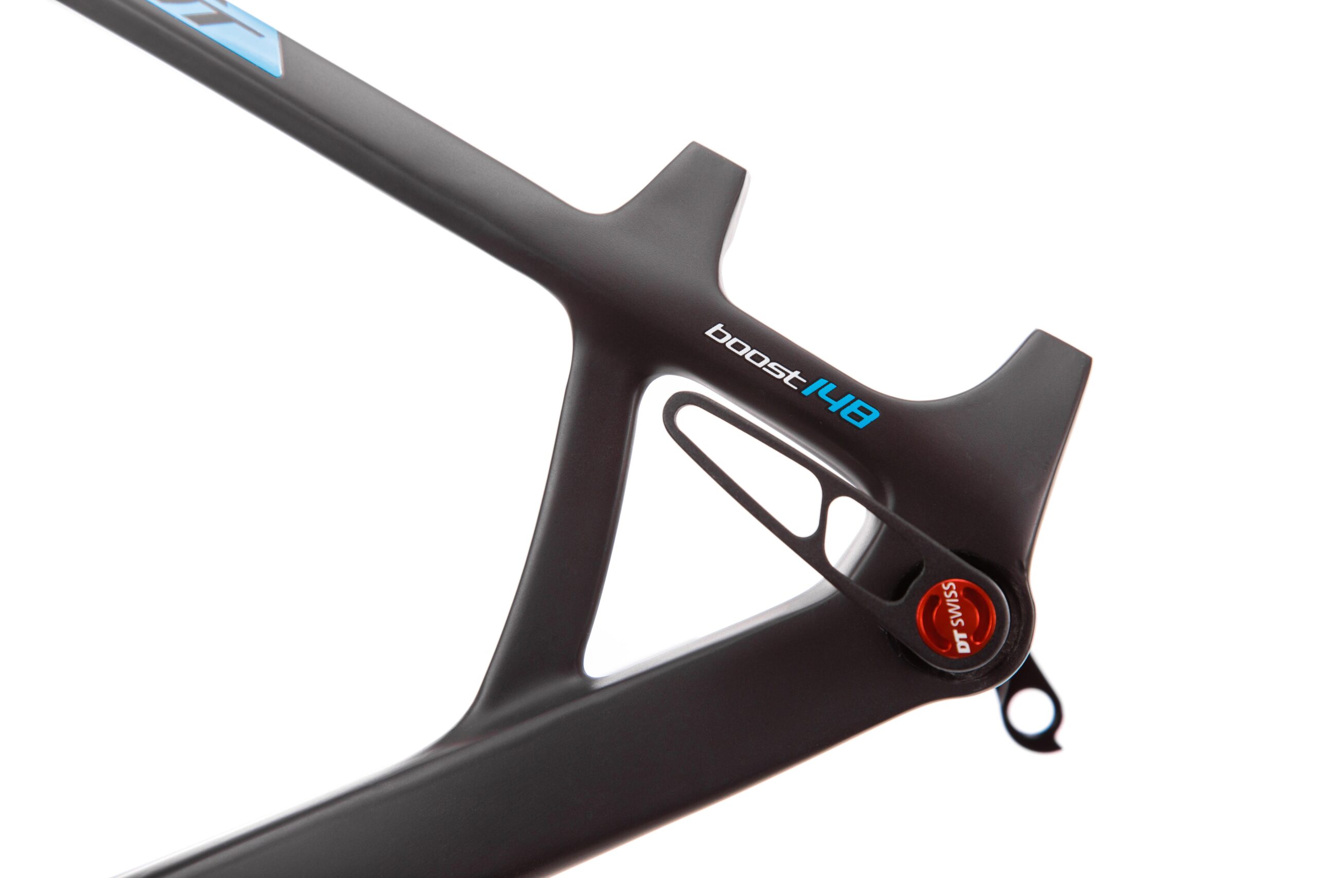 Pivot LES 27.5: Close-up view of a black bicycle frame featuring the text "boost 148." The frame has a sleek design with a cutout section for weight reduction and fitting components. The image highlights the frame's modern construction and detailing, including an orange and silver component strategically positioned on the frame.