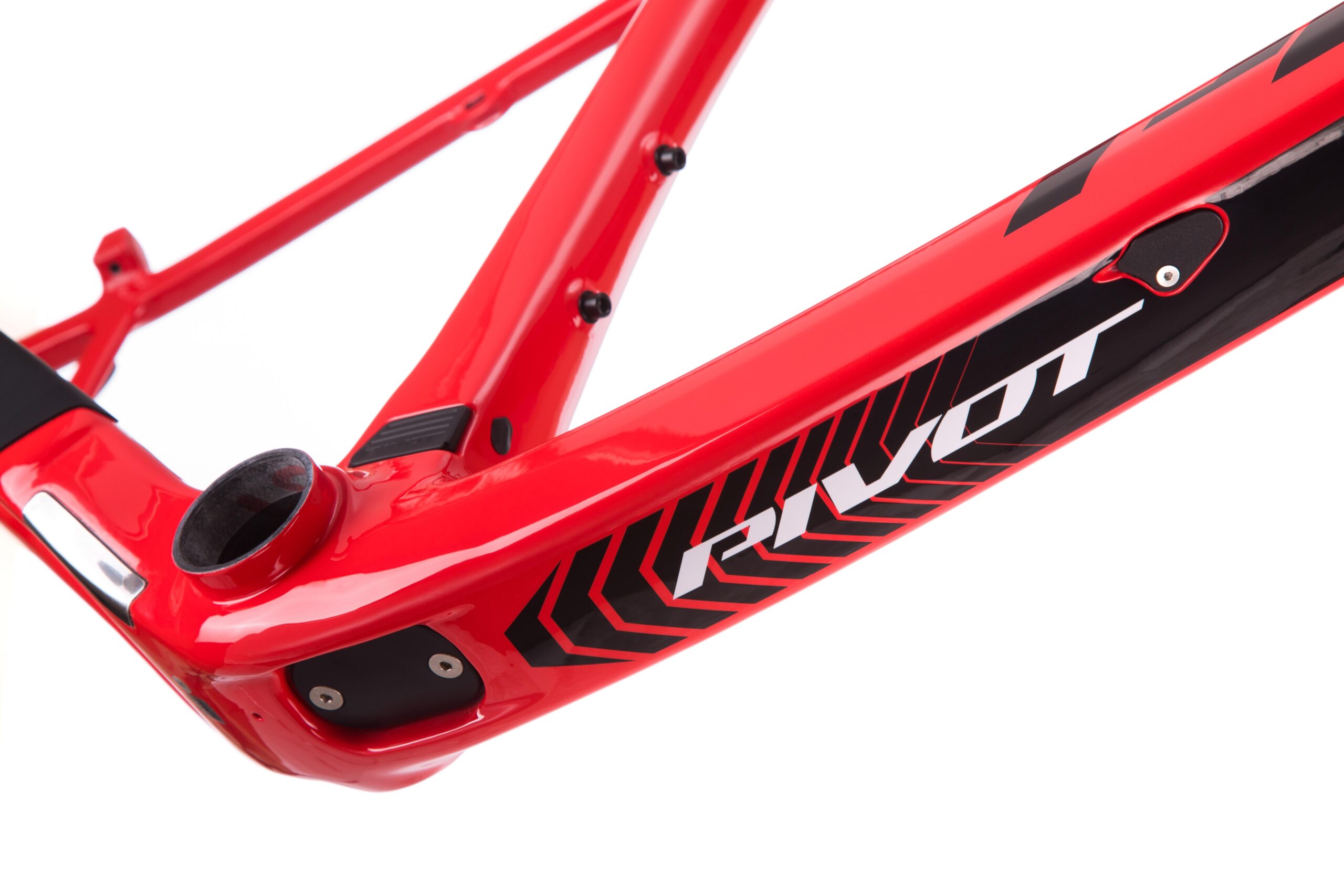 Pivot LES 27.5: Close-up of a red bicycle frame featuring the brand name "Pivot" in bold lettering, with a sleek design and black accents. The image highlights the frame's construction and details, emphasizing its sporty aesthetics.