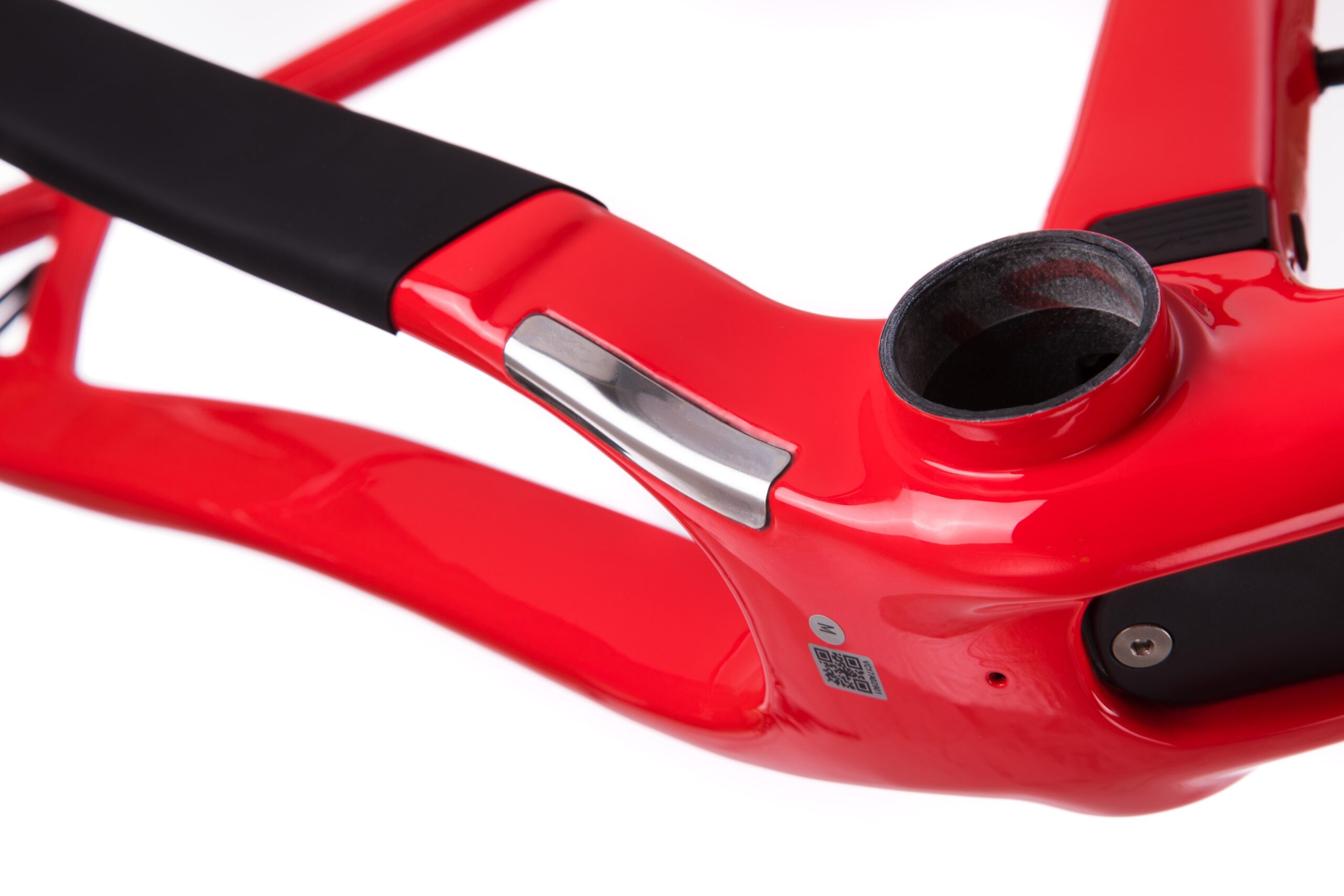 Pivot LES 27.5: Close-up view of a modern red bicycle frame with a sleek design, highlighting the connection point for the bottom bracket and some metallic detailing. The frame features a glossy finish and a black grip area, suitable for various biking applications.