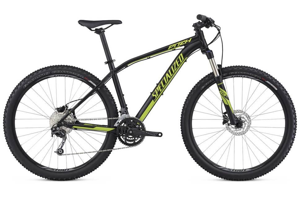 Specialized Pitch Comp: Mountain bike by Specialized, model Pitch, featuring a black frame with green accents, disc brakes, and wide tires designed for off-road cycling.