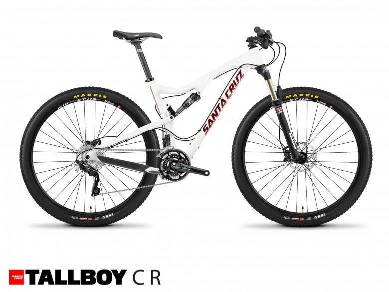 Santa Cruz Tallboy Carbon: A white mountain bike with black wheels and red accents, featuring the brand name "Santa Cruz" prominently displayed on the frame. The bike is designed for off-road cycling, showcasing a lightweight frame and advanced suspension components. The wheels are fitted with Maxxis tires, indicating a focus on performance and durability. The image includes the text "TALLBOY CR" at the bottom.