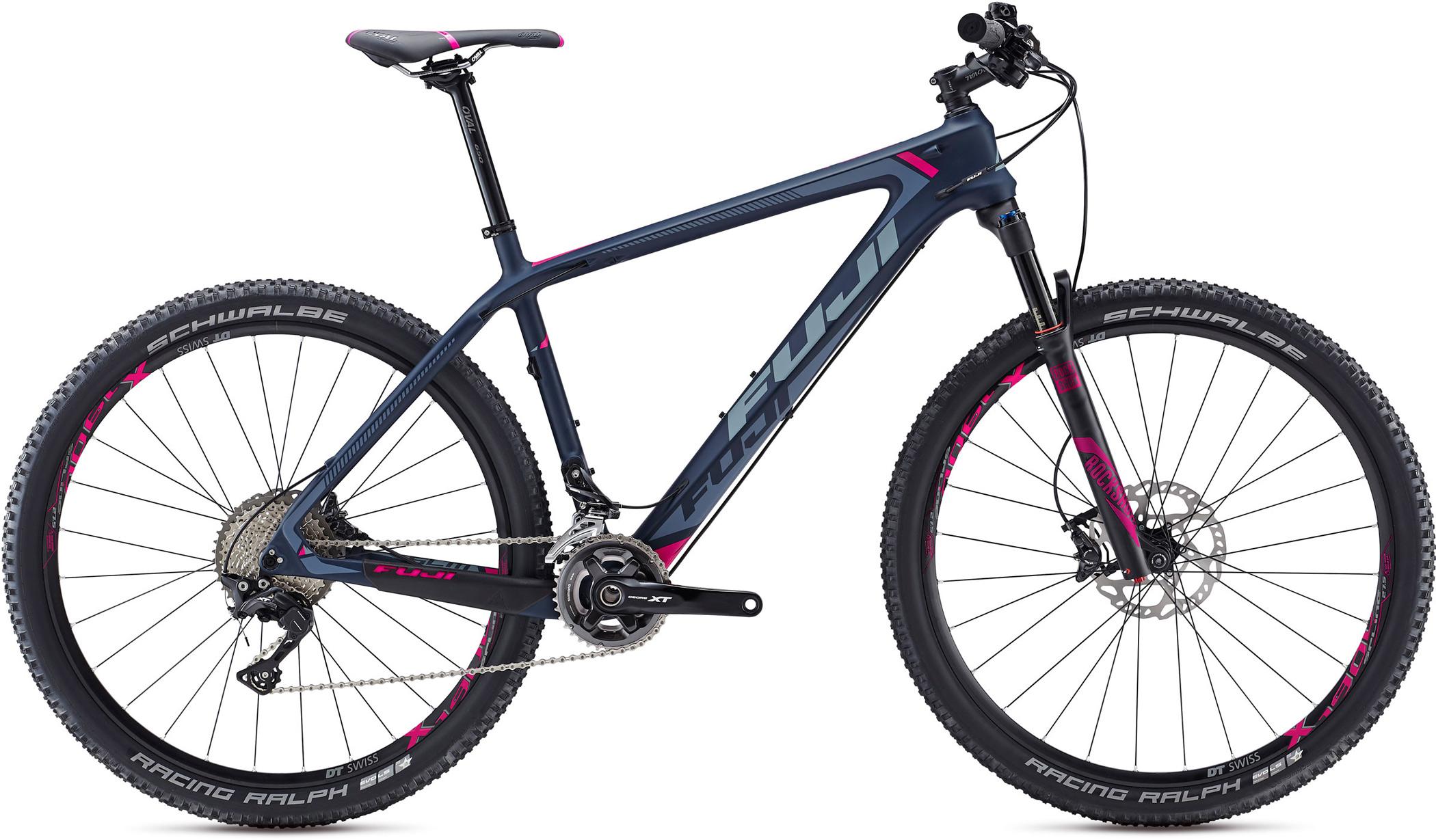 Fuji Fuji SLM 2.5: A modern mountain bike with a sleek navy and pink design, featuring large wheels with aggressive tread patterns, a lightweight frame, and a prominent brand logo. The bike includes disc brakes and a gear system, making it suitable for off-road riding.