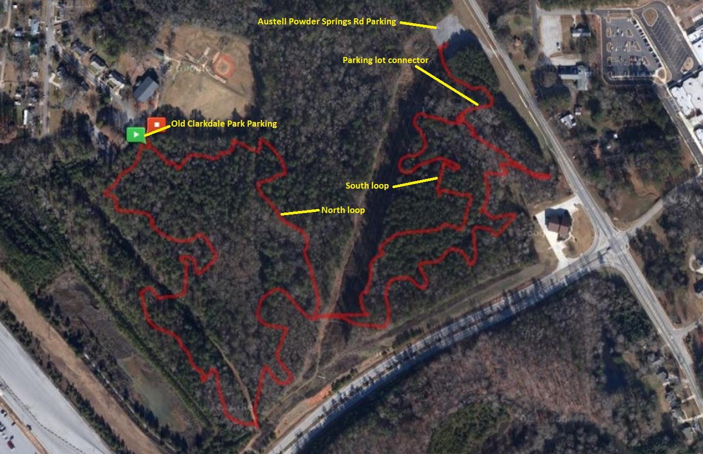 Aerial map of Old Clarkdale Park featuring outlined hiking trails, labeled parking areas, and loops. The map indicates the North and South loops of the trails, parking locations including Old Clarkdale Park Parking and Austell Powder Springs Rd Parking, and a parking lot connector. Austell Threadmill MTB Park (Closed) mountain bike trail.