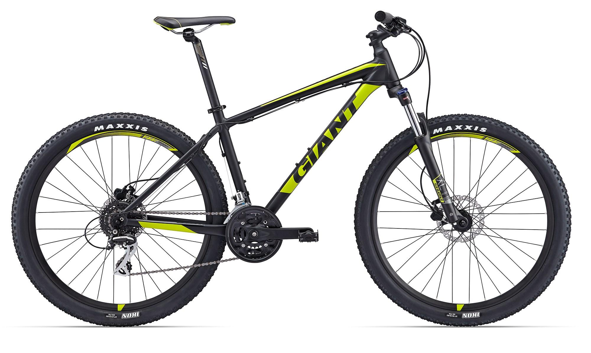 2017 Giant Talon 3: A black and yellow mountain bike with wide tires, featuring a lightweight frame, front suspension, and disc brakes. The bike has branding that reads "GIANT" prominently on the frame and "MAXXIS" on the tires, showcasing its rugged design suitable for outdoor biking and trails.