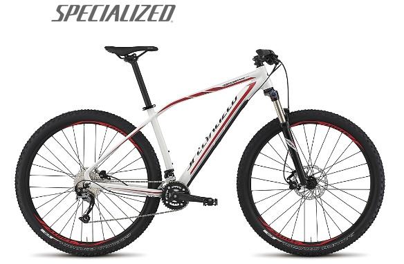 Specialized Rockhopper Comp 29: Alt text: A white and red mountain bike with large black wheels and disc brakes, featuring a lightweight frame and sporty design, alongside the brand name "Specialized" displayed above.