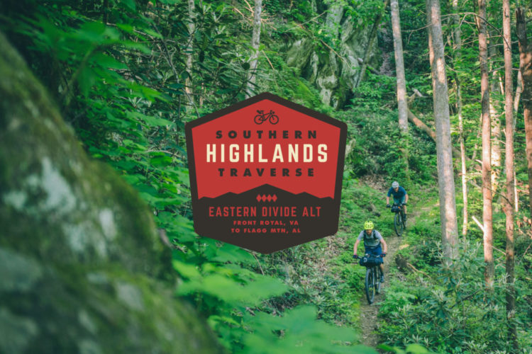 Two mountain bikers navigating a lush, green forest trail, with vibrant foliage surrounding them. An overlay graphic highlights "Southern Highlands Traverse" and indicates the route from Front Royal, VA, to Flagg Mountain, AL.