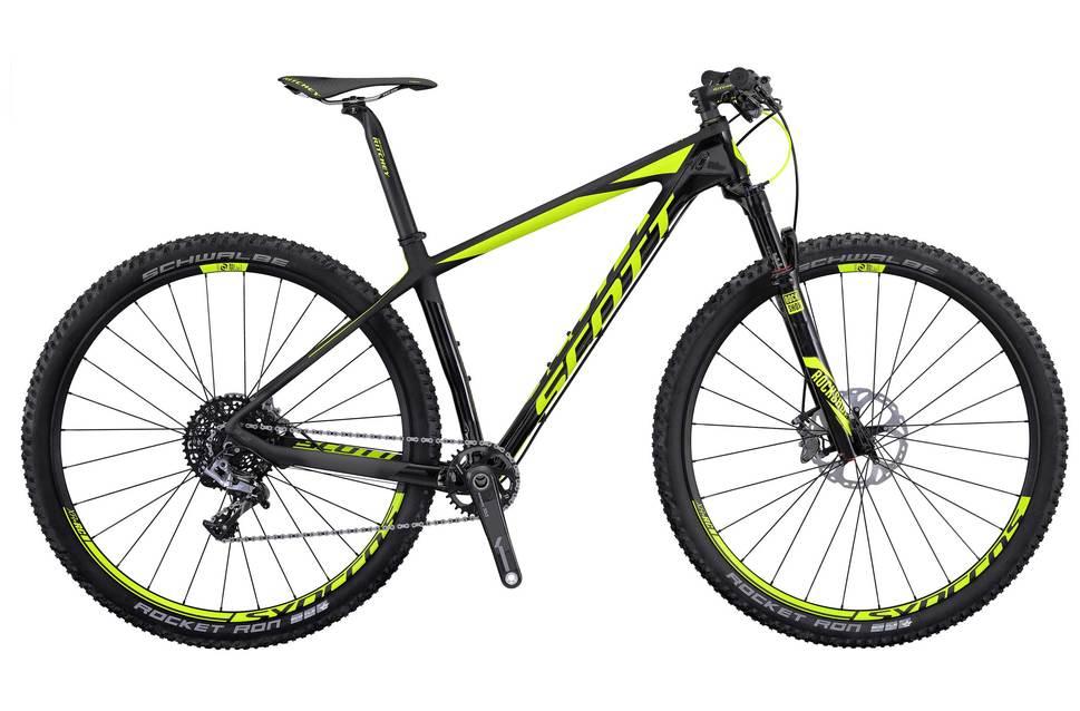 Scott Scale 900 RC: Black and yellow mountain bike with a lightweight frame, designed for off-road cycling. The bike features thick tires suitable for rugged terrain and a modern, sleek design. The brand name is prominently displayed on the frame.