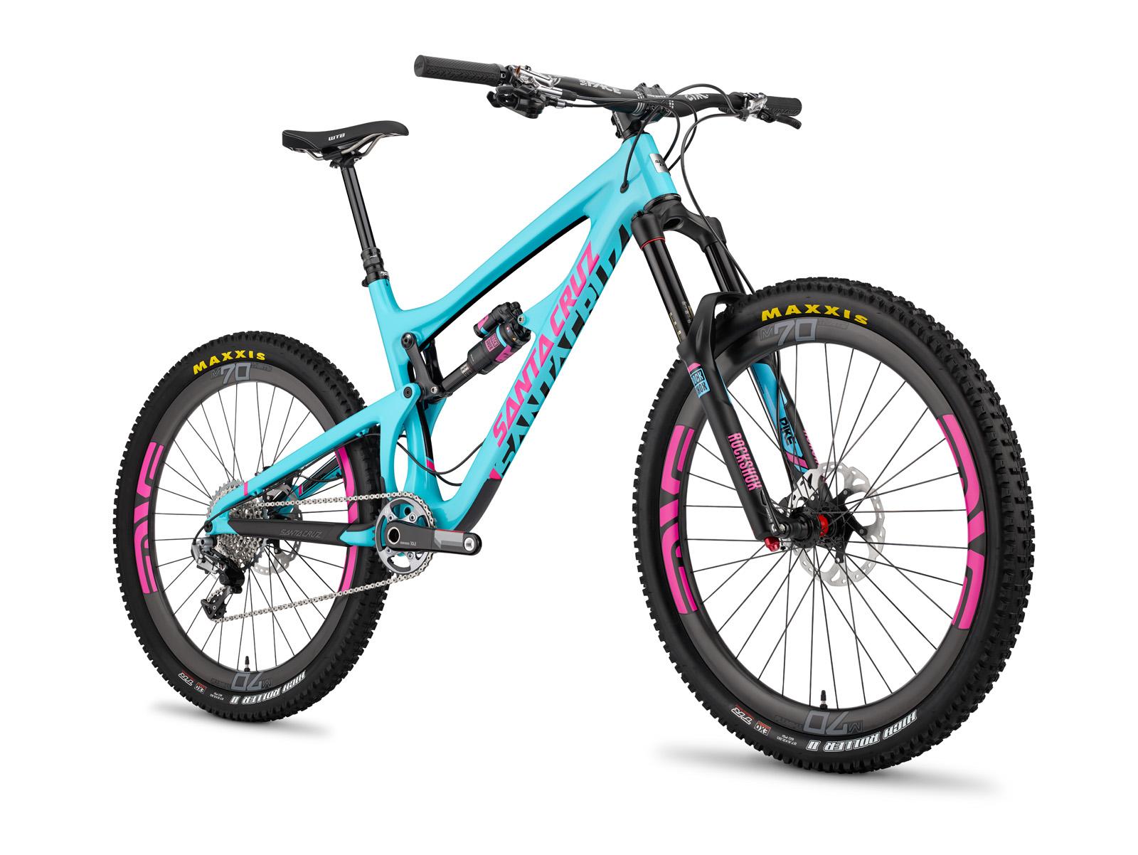 Santa Cruz Nomad: A vibrant blue and pink mountain bike with a sturdy design, featuring thick tires, a suspension system, and prominent branding on the frame. The bike is angled to showcase its dual suspension, handlebar, and distinctive tire tread, set against a clean, white background.