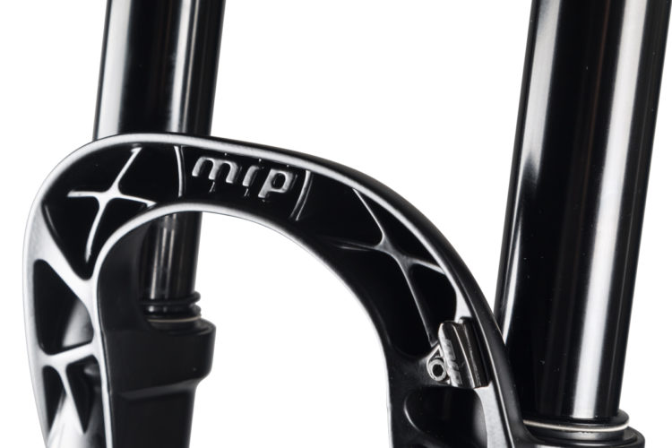 Close-up view of a mountain bike fork showcasing the MRP brand logo, with glossy black stanchions and a distinctive linkage design for performance and stability.