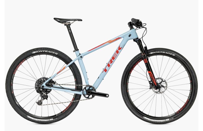 Trek Procaliber: A blue and orange Trek mountain bike with a lightweight frame, featuring disc brakes, knobby tires, and a sleek design, displayed against a white background.