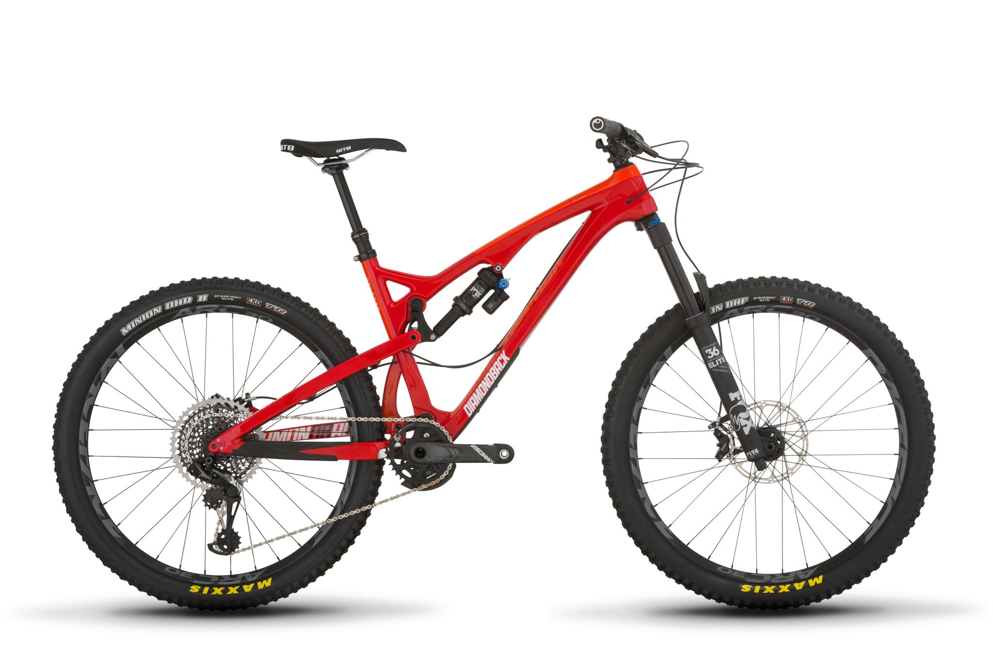 Diamondback Release Carbon: A vibrant red mountain bike with a lightweight frame, featuring thick, knobby tires designed for off-road trails. The bike is equipped with front and rear suspension, a mechanical drivetrain, and disc brakes, showcasing a modern design ideal for adventurous cycling. The background is plain white, highlighting the bike's details.