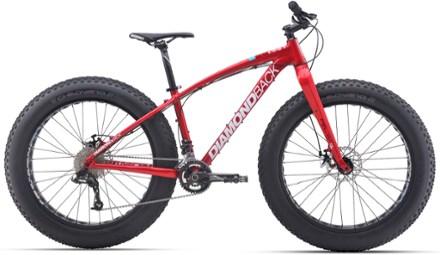 Diamondback El Oso Grande: A bright red fat tire bike featuring wide tires, a sturdy frame, and a comfortable seat, designed for off-road cycling. The bike is branded with the name "Diamondback" on its frame.