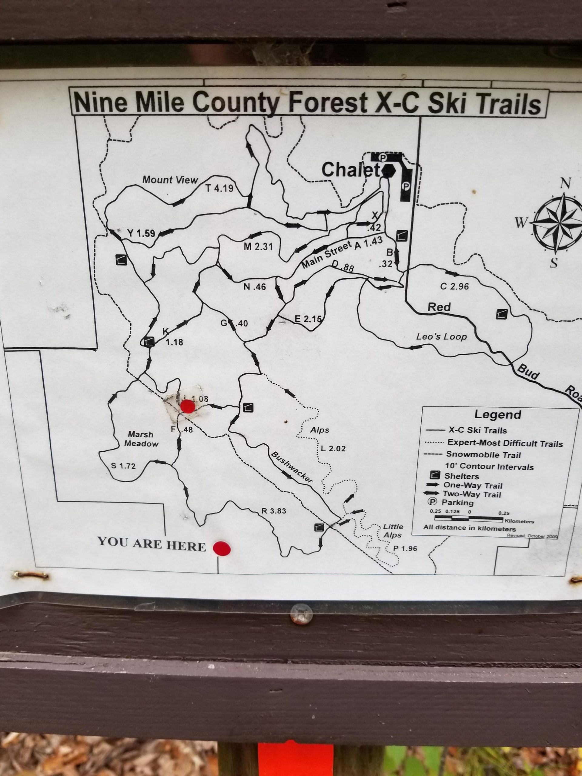 Map of the Nine Mile County Forest cross-country ski trails, including marked trails, distances, and a legend. A red marker indicates the user's current location, labeled "YOU ARE HERE." The map features various trails such as Mount View, Marsh Meadow, and others, with a chalet shown at the top of the map. Nine Mile mountain bike trail.