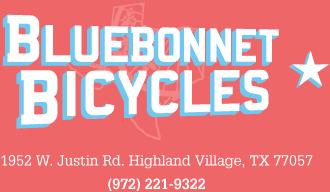 Logo for Bluebonnet Bicycles, featuring the business name in bold blue letters on a pink background, with the address and phone number below.