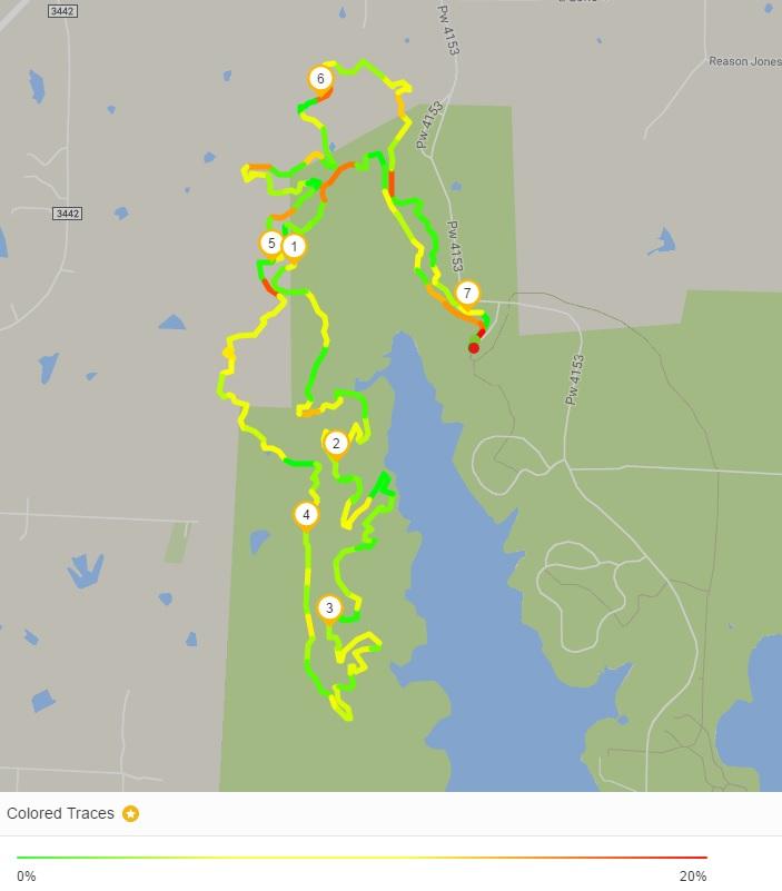 Map showing a trail route with colored traces indicating different sections. Key points are marked with numbers, and the colors from green to red suggest varying conditions or elevations throughout the trail. The map includes surrounding areas and paths, along with a legend indicating the color representation. Johnson Branch mountain bike trail.