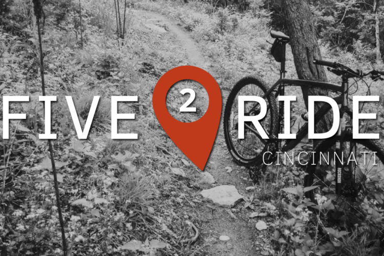A stylized graphic featuring the text "FIVE 2 RIDE CINCINNATI" overlaying a black and white image of a forested biking trail, with a bike positioned to the right. A location pin graphic in red emphasizes the "2." The overall theme suggests biking and outdoor adventure in Cincinnati.