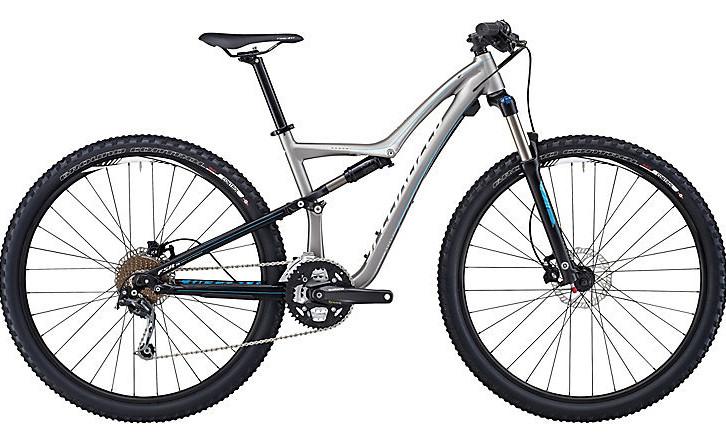 Specialized Rumor: A silver and black mountain bike with a lightweight frame, dual suspension, and knobby tires. The bike features a curved top tube, adjustable seat post, and a compact gear setup, designed for off-road cycling.