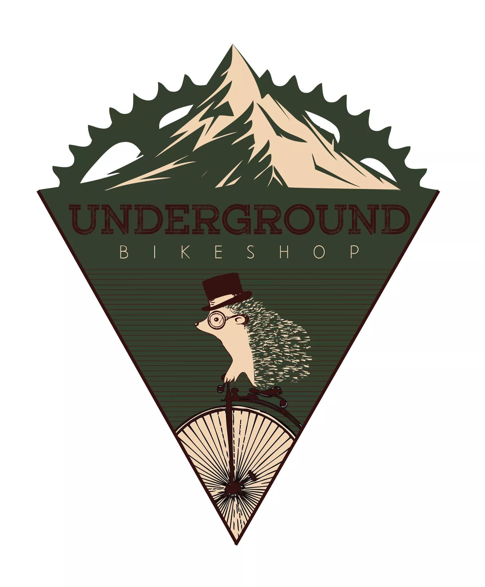 Illustration of a quirky logo for "Underground Bikeshop," featuring a hedgehog wearing glasses and a top hat, riding a vintage bicycle with a large front wheel. The design is set against a backdrop of a mountain silhouette and incorporates earthy tones. The text "UNDERGROUND" is prominently displayed above the word "BIKESHOP."