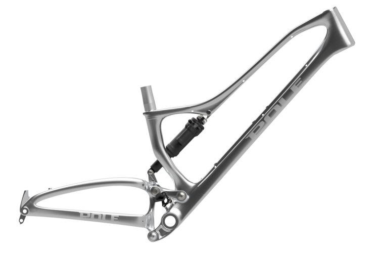 Aluminum bicycle frame with a sleek silver finish, featuring a suspension system and bold branding on the side.