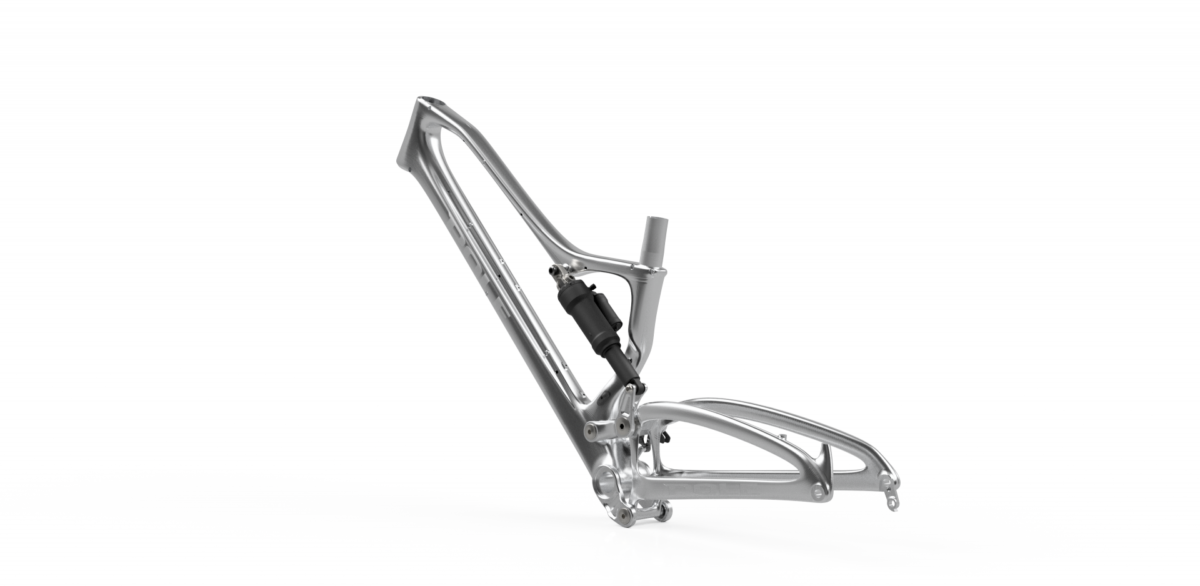 An aluminum bicycle frame displayed at an angle, featuring a rear shock absorber, with a sleek, modern design and minimalistic aesthetic against a white background.