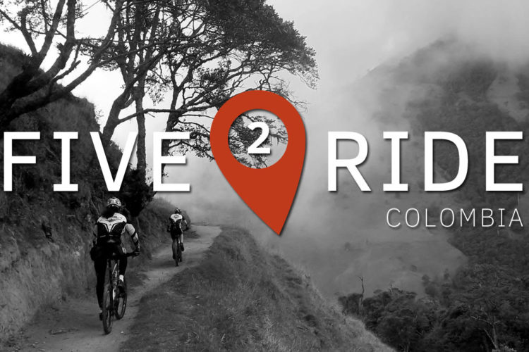 Black and white image featuring two cyclists riding on a narrow path in a mountainous landscape, with fog rolling in. Overlayed text reads "FIVE 2 RIDE" and "COLOMBIA," with a location pin icon displayed in red.