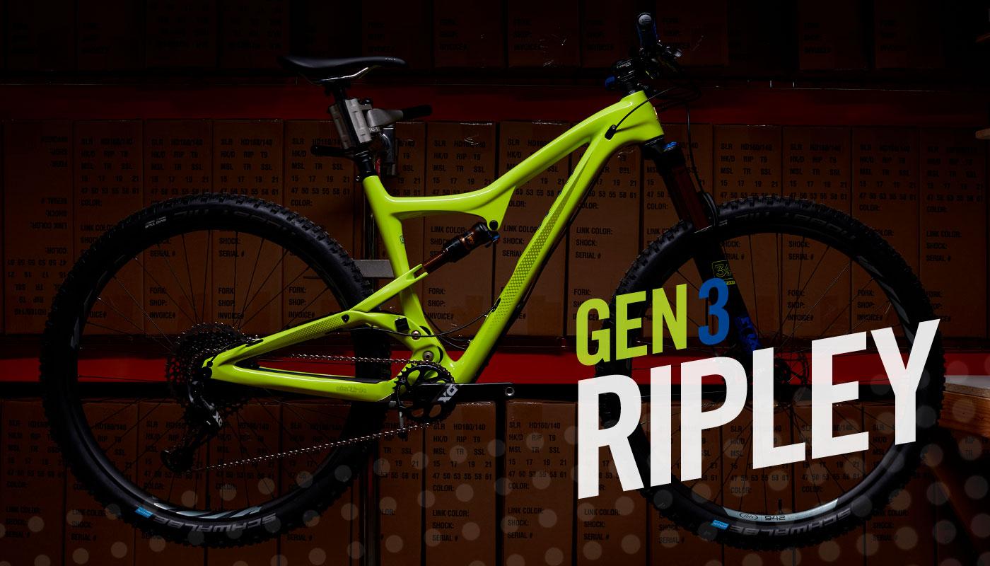 Ibis Ripley: A bright green mountain bike frame displayed against a backdrop of stacked boxes. The image features bold text that reads "GEN 3 RIPLEY," highlighting the bike model. The setting is dimly lit, emphasizing the bike's vivid color and design.