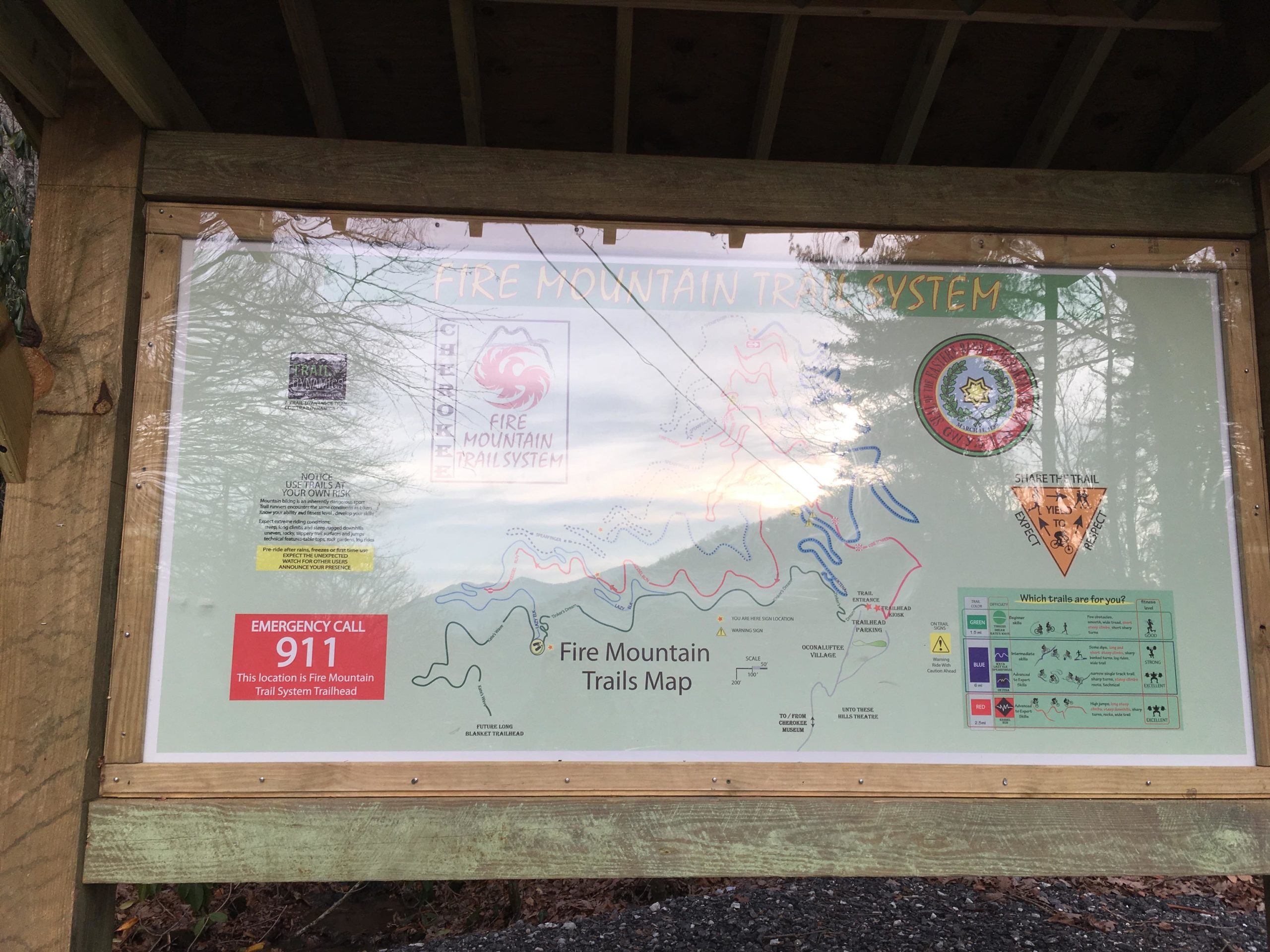 Map display of the Fire Mountain Trail System, featuring a detailed trail map, safety information, and emergency contact instructions. Fire Mountain Trail System mountain bike trail.