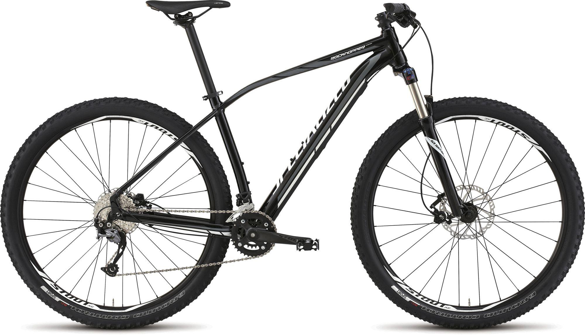 Specialized Rockhopper Comp 29: A black mountain bike with a lightweight aluminum frame, featuring thick tires designed for off-road terrain, a front suspension fork, and a multi-speed drivetrain. The bike is shown from the side, highlighting its components such as the disc brakes and gear shifting system.