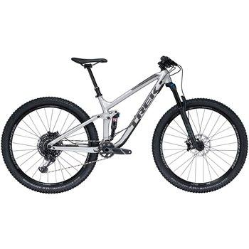 Trek Fuel EX 8 29: Alt text: A gray Trek mountain bike with wide tires, front suspension, and a modern frame design, positioned against a neutral background.