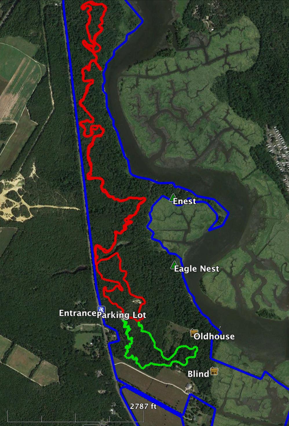 Map showing hiking trails and points of interest in a natural reserve, with red indicating one trail, green a secondary trail, and blue outlining the reserve boundaries. Key locations labeled include "Entrance Parking Lot," "Enest," "Eagle Nest," "Oldhouse," and "Blind," along with elevation marked at 2787 ft. The bluffs mountain bike trail.