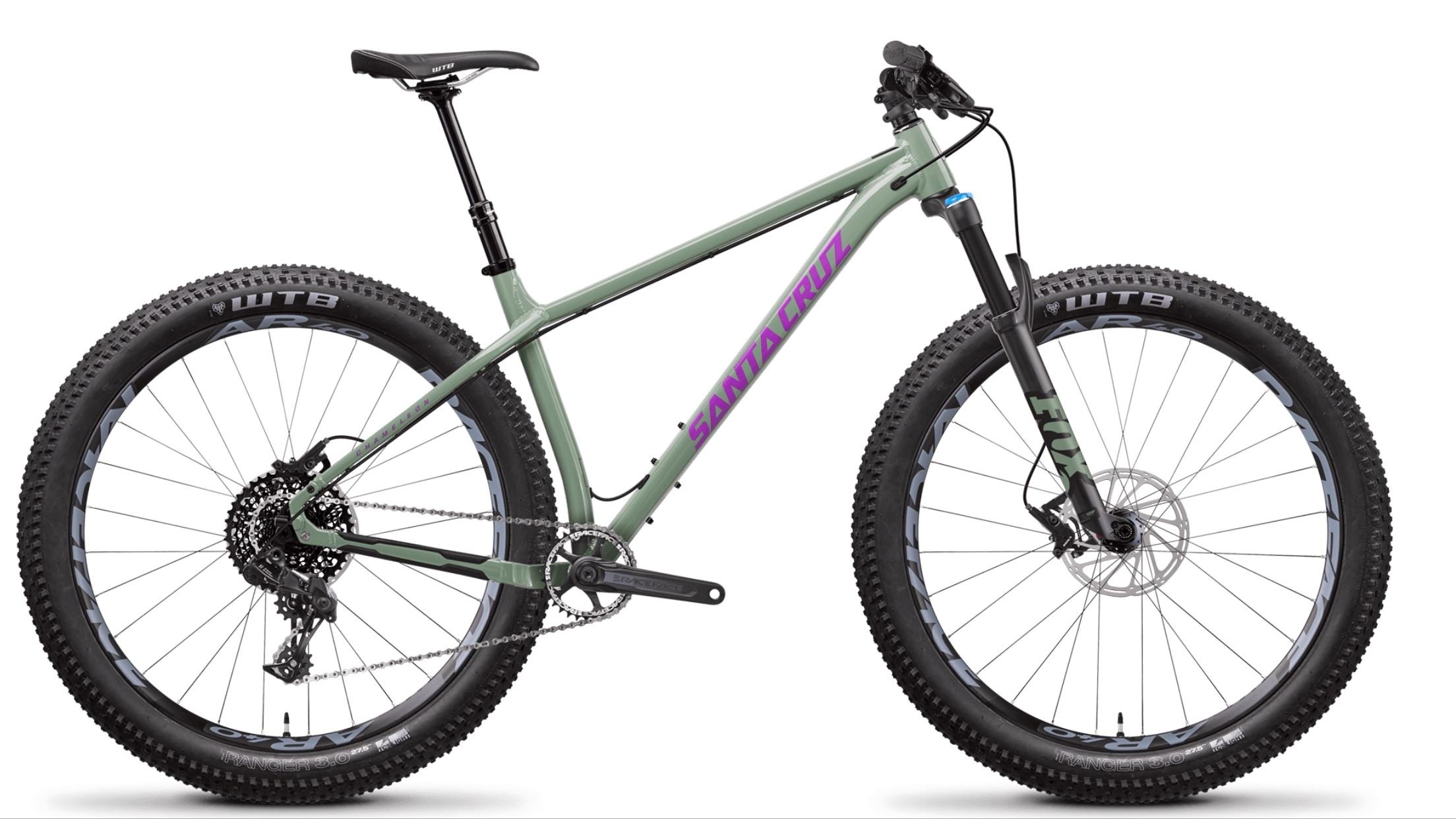 Santa Cruz Chameleon: Alt tag: A green mountain bike with wide tires, featuring disc brakes, a dropper seat post, and a prominent "Santa Cruz" logo in purple on the frame, displayed against a white background.