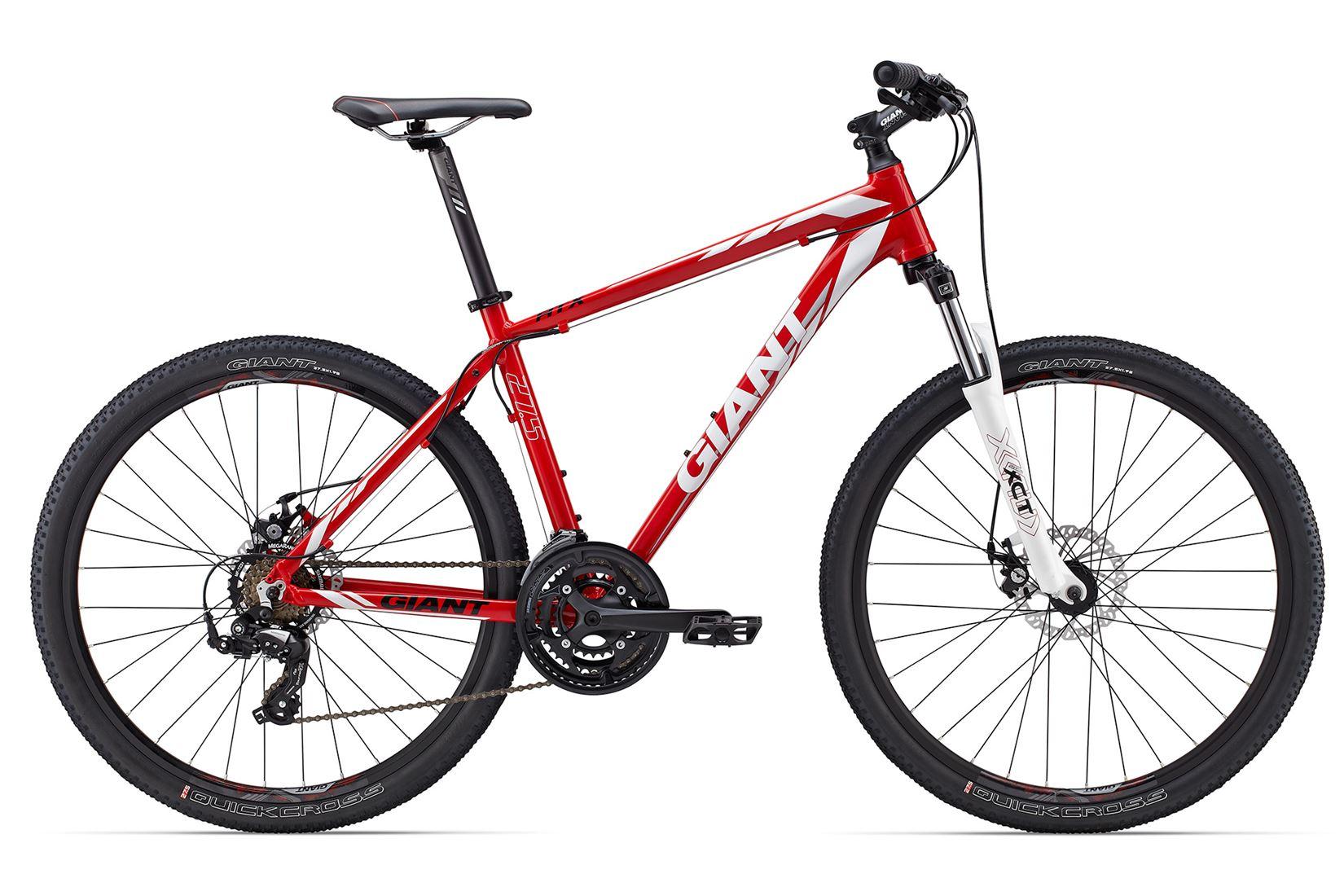 Giant ATX 27.5 2: A red mountain bike with a sturdy frame, designed for off-road cycling. The bike features wide black tires, disc brakes, a gear system, and a white front fork. The brand name "Giant" is prominently displayed on the frame and tires.
