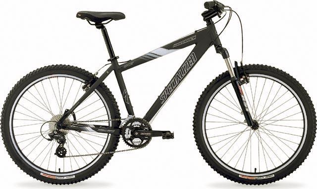 Specialized hardrock: A black Specialized mountain bike with wide tires and a lightweight frame, featuring front suspension and multiple gears. The bike is positioned against a plain white background, showcasing its design and components.