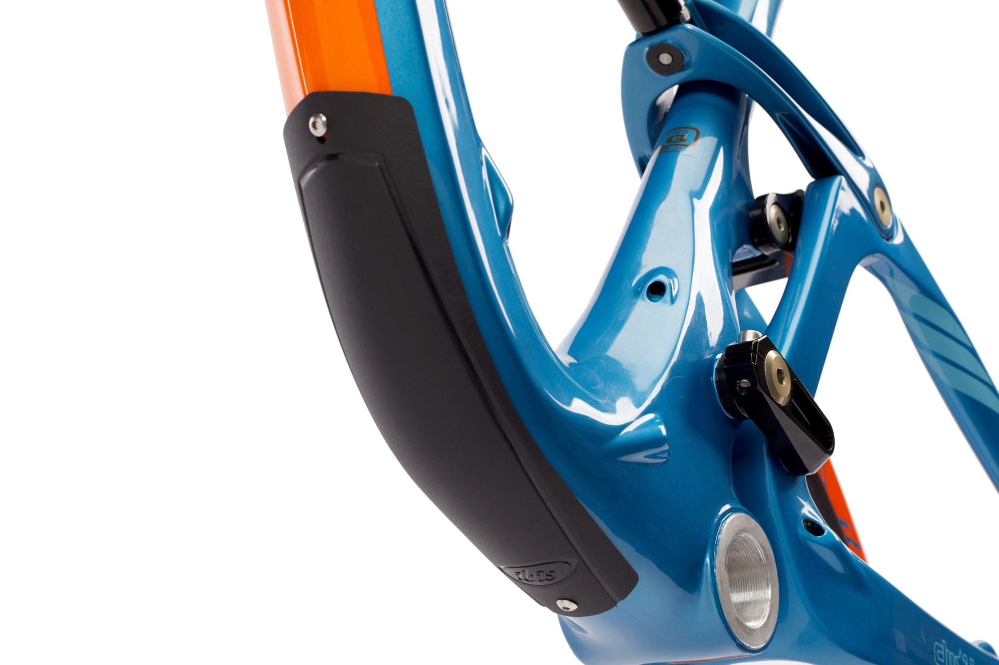 Ibis RipMo: Close-up of a bicycle frame featuring a vibrant blue finish with orange accents. The image highlights the detailed design of the frame's welds and components, including a protective rubber guard and various mounting points. The background is plain white, emphasizing the bike frame's smooth curves and metallic sheen.