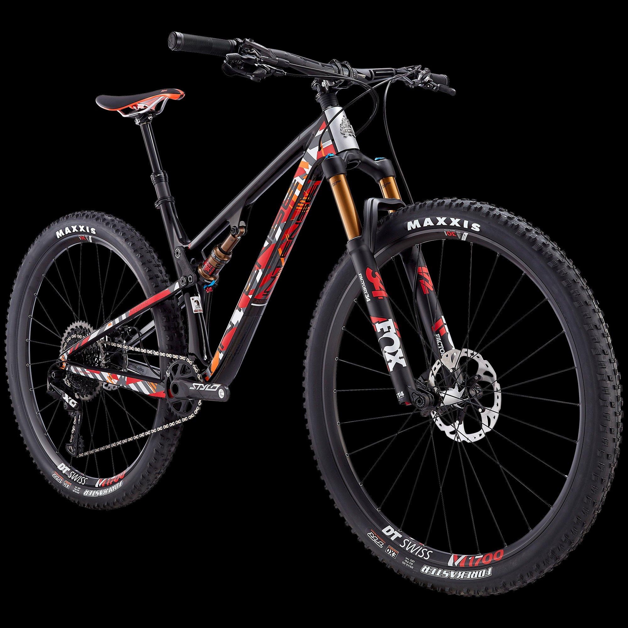 Intense Sniper Trail: A modern mountain bike featuring a sleek black and red design, front suspension with golden forks, and wide tires. The bike is positioned at an angle against a black background, showcasing its lightweight frame and detailed components, including the brand logos on the tires and a disc brake setup.