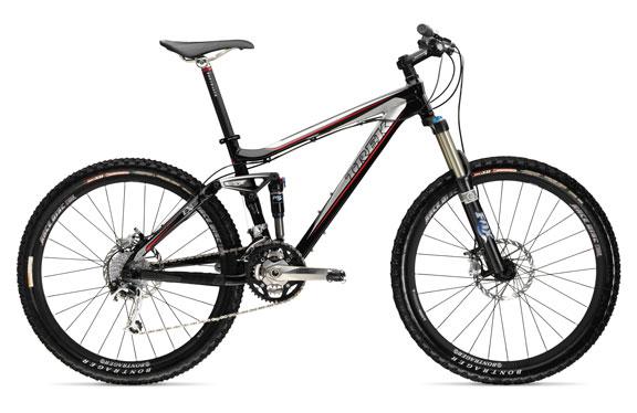 Trek Fuel EX 8: A black and red mountain bike with thick tires, front suspension, and a gear system, positioned on a white background.