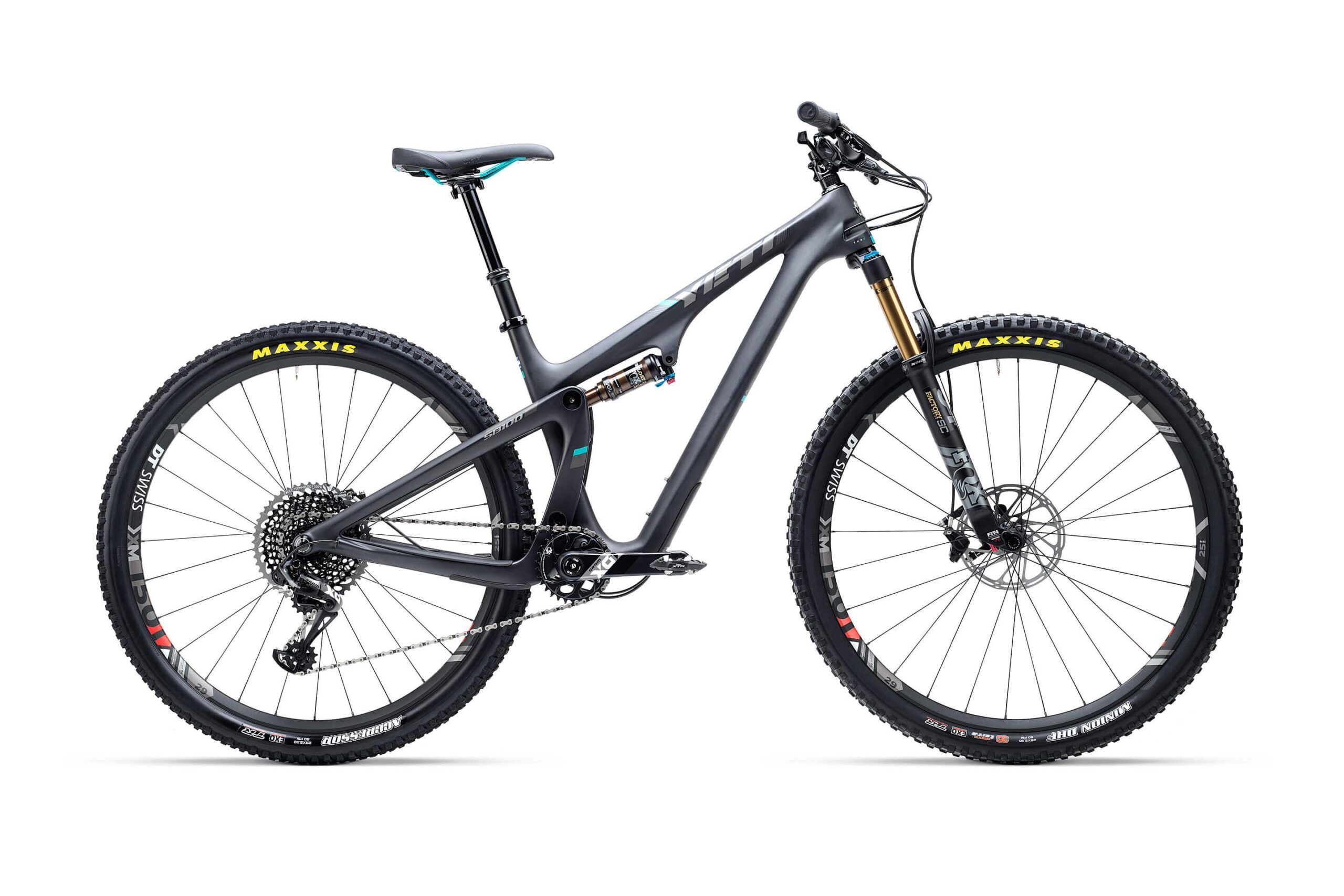 Yeti SB100: Mountain bike with a sleek black frame, featuring front suspension, disc brakes, and rugged tires designed for off-road terrain. The bike is positioned with its side visible against a plain white background, showcasing its design and components.