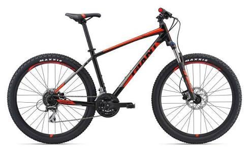 Giant Giant Talon 3: A black and orange mountain bike with a sturdy frame, featuring front suspension, disc brakes, and thick tires suitable for off-road riding. The bike has a sleek design and is equipped with Maxxis tires.