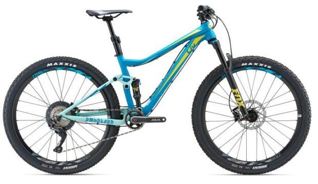 LIV Embolden 1: A blue and yellow mountain bike is depicted, featuring a lightweight frame, front suspension, and wide tires. The bike showcases Maxxis tires and a sleek design suitable for off-road cycling.