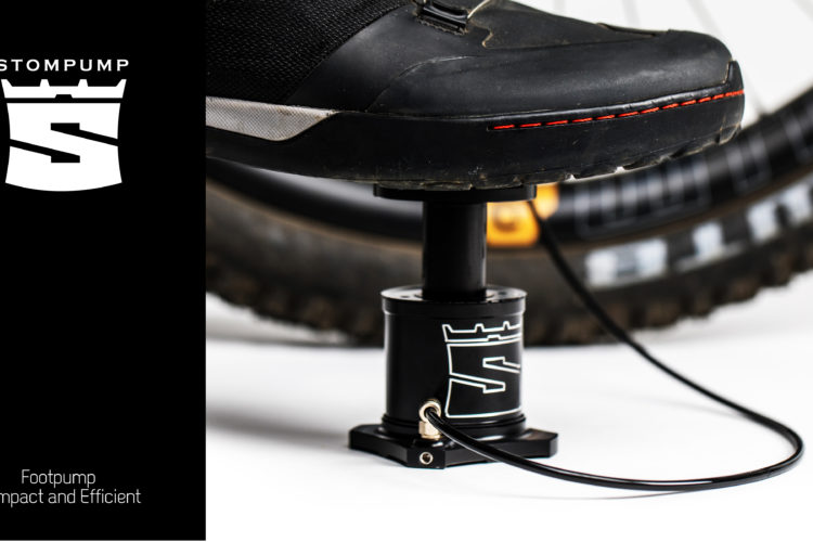 Close-up image of a foot pump designed for bicycles, with a foot resting on the pump. The background features part of a bicycle tire. The image includes a brand logo and the tagline "Footpump - Compact and Efficient."