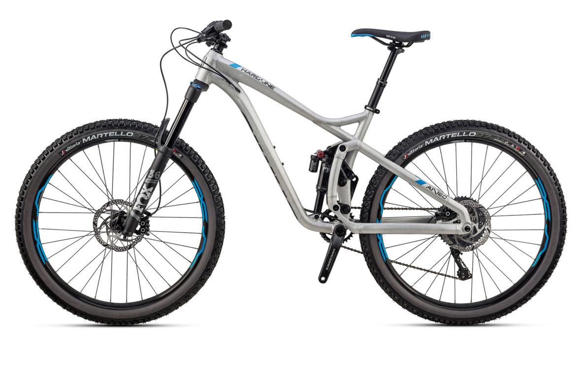 Jamis Hardline: A modern mountain bike featuring a lightweight gray frame with blue accents, front suspension, and rugged tires designed for off-road terrain. The bike has disc brakes and a sleek design suitable for trail riding.