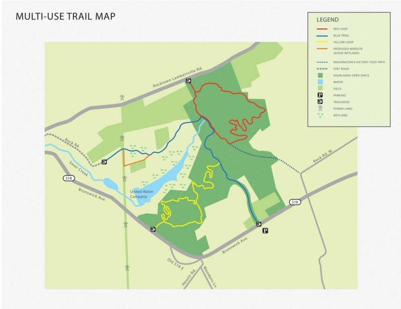Alt text: "A detailed multi-use trail map showing different hiking and biking routes in a green area. The map includes a legend with color-coded trails: red for the loop, blue for another trail, and yellow for a proposed route. Key features such as parking, water, dirt roads, and wetlands are also marked." Water Company mountain bike trail.