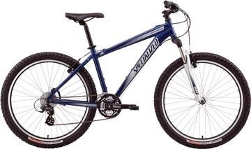 Specialized HardRock: A blue mountain bike with a sturdy frame, wide tires, and front suspension, displayed in a side view. The bike features a black seat, handlebars, and gear shifters.